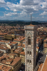 A sweeping view of the skyline and rooftops of Florence including Giotto's bell tower, from the top of the cathedral.