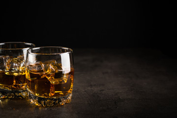 Whiskey in the glasses on black.