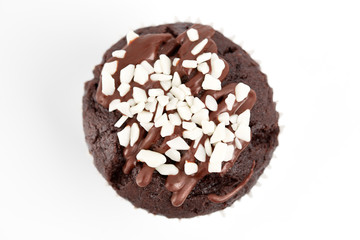 Tasty chocolate cupcakes on white background. Chocolate caramel cupcake and butterscotch syrup. Chocolate cupcake isolated on white.