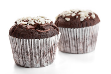 Tasty chocolate cupcakes on white background. Chocolate caramel cupcake and butterscotch syrup. Chocolate cupcake isolated on white.