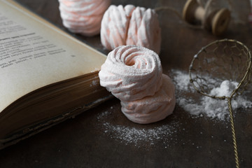 Homemade zephyr and mint on an old wooden table covered 