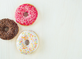 Donuts with icing on white background. Top view