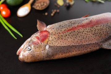 Fresh whole raw trout with cooking ingredients