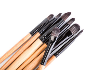 Various makeup brushes isolated over white. wooden makeup brushes. Duo fibre foundation makeup brush. Style. Fashion. Visage. Cosmetics.