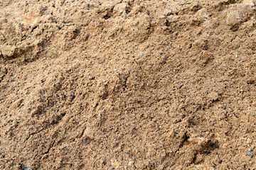 Large pile of construction sand close up as texture and background