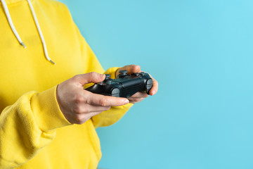 Young woman holding modern joystick in her hands