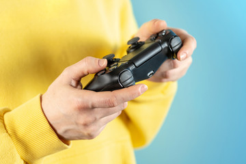 Young woman holding modern joystick in her hands