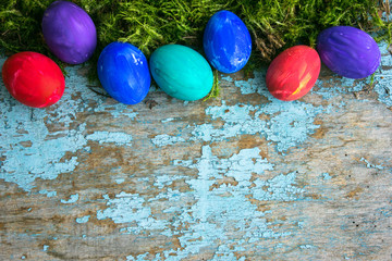 Painted easter eggs for Easter in front of a blue grunge background