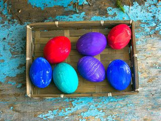 Painted easter eggs for Easter in front of a blue grunge background