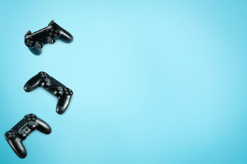 Photo of modern black gamepad against colorful background