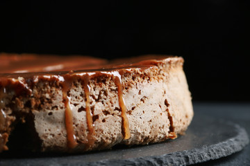 pie with caramel close up on dark background. cake with banana and caramel