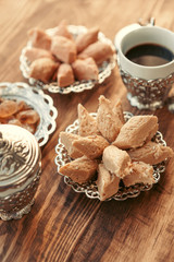 Turkish sweets with coffee on a wooden table
