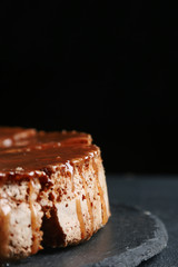 pie with caramel close up on dark background. cake with banana and caramel