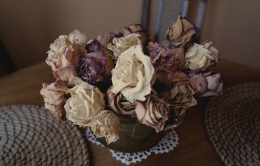 Decoration: dried roses in a retro vase.