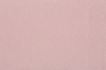 Fototapeta premium Pink cotton textile - close up of fabric texture. Cotton Fabric Texture. Top View of Cloth Textile Surface. Pink Clothing Background. Text Space. Abstract background and texture for designers.