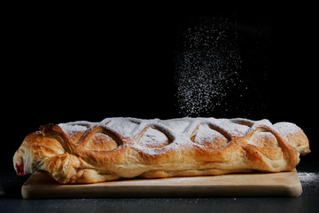 man in apron serving strudel. recipe of strudel or pie. baker decorating concept