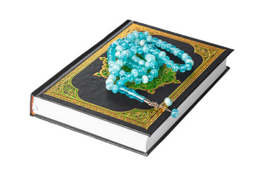 Islamic Book Holy Quran and beads on withe background