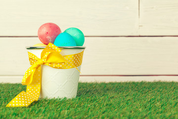 Easter eggs and chickens on green grass