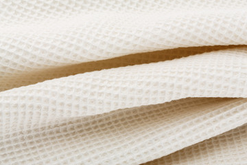 White corrugated cotton textile - close up of fabric texture. Cotton Fabric Texture. White Clothing Background. Text Space. Abstract background and texture for designers.