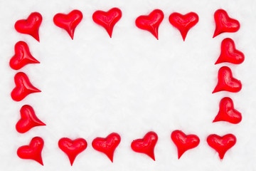 Red hearts on white fabric background