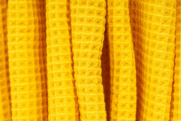 Yellow corrugated cotton textile - close up of fabric texture. Cotton Fabric Texture. Yellow Clothing Background. Text Space. Abstract background and texture for designers.