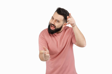 Fototapeta premium A cute young bearded man shows emotionally