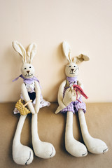 Fototapeta na wymiar A pair of handmade Easter rabbits made of cloth.