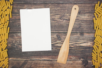 Tubetti and white paper on wooden table