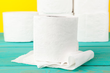 Toilet paper stacks  on bright yellow background