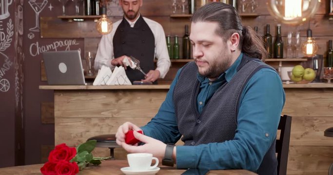 Man gets excited before a proposal to his girlfriend. Handsome man checks the diamond ring he intends to give to his future wife.