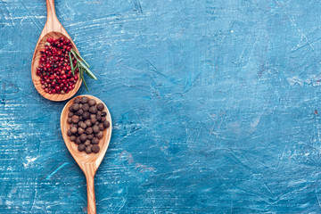 Spice in wooden spoon on blue wooden background top view