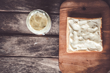 Bread and coffee on wooden background