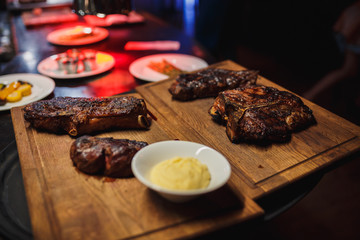 Steaks on a wooden tray