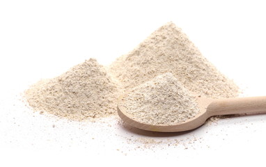 Integral barley flour with wooden spoon isolated on white background