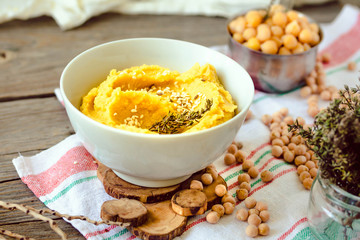 Traditional Middle east appetizer Hummus served with herbs, seasoned with in vintage ceramic plate.