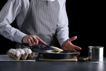 man pouring dough for pie. cake making concept