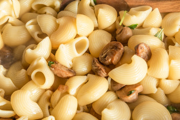 Pasta carbonara with mushrooms is cooked in a pan - Italian cuisine