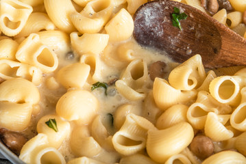 Pasta carbonara with mushrooms is cooked in a pan - Italian cuisine