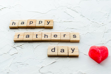 Father's day concept. Red heart and greetings on a white background. Close up