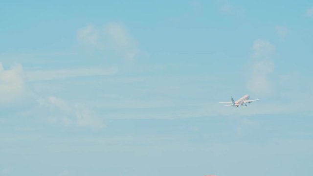 Airplane taking off from the airport against the blue sky.