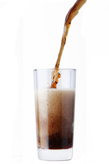 cola pouring in glass isolated on white background