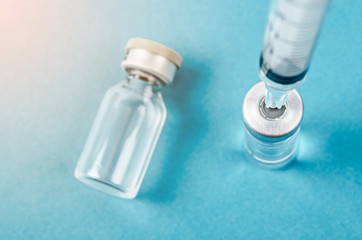 Vaccine vial dose with needle syringe, medical concept vaccination.