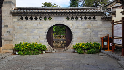 A circular door in Tuanshan Historical Village in Yunnan. A traditional walled village in Yunnan, China
