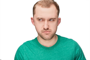 Fototapeta premium A funny young man in a green shirt shows