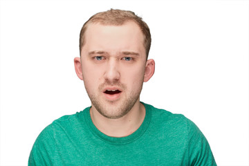 Obraz premium A funny young man in a green shirt shows disappointment