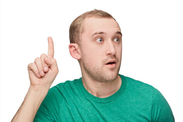 A funny young man in a green shirt shows one