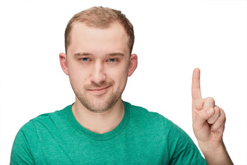 Fototapeta premium A funny young man in a green shirt shows one