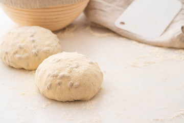 Balls of dough covered with wheat flour ready for baking. Copy space.