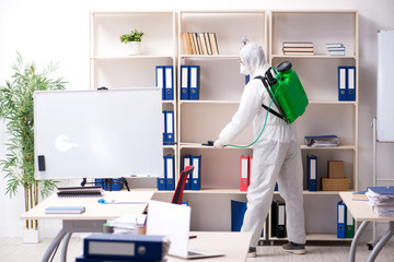 Professional contractor doing pest control at office