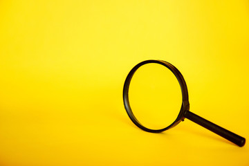 Magnifying glass on yellow background. Search concept